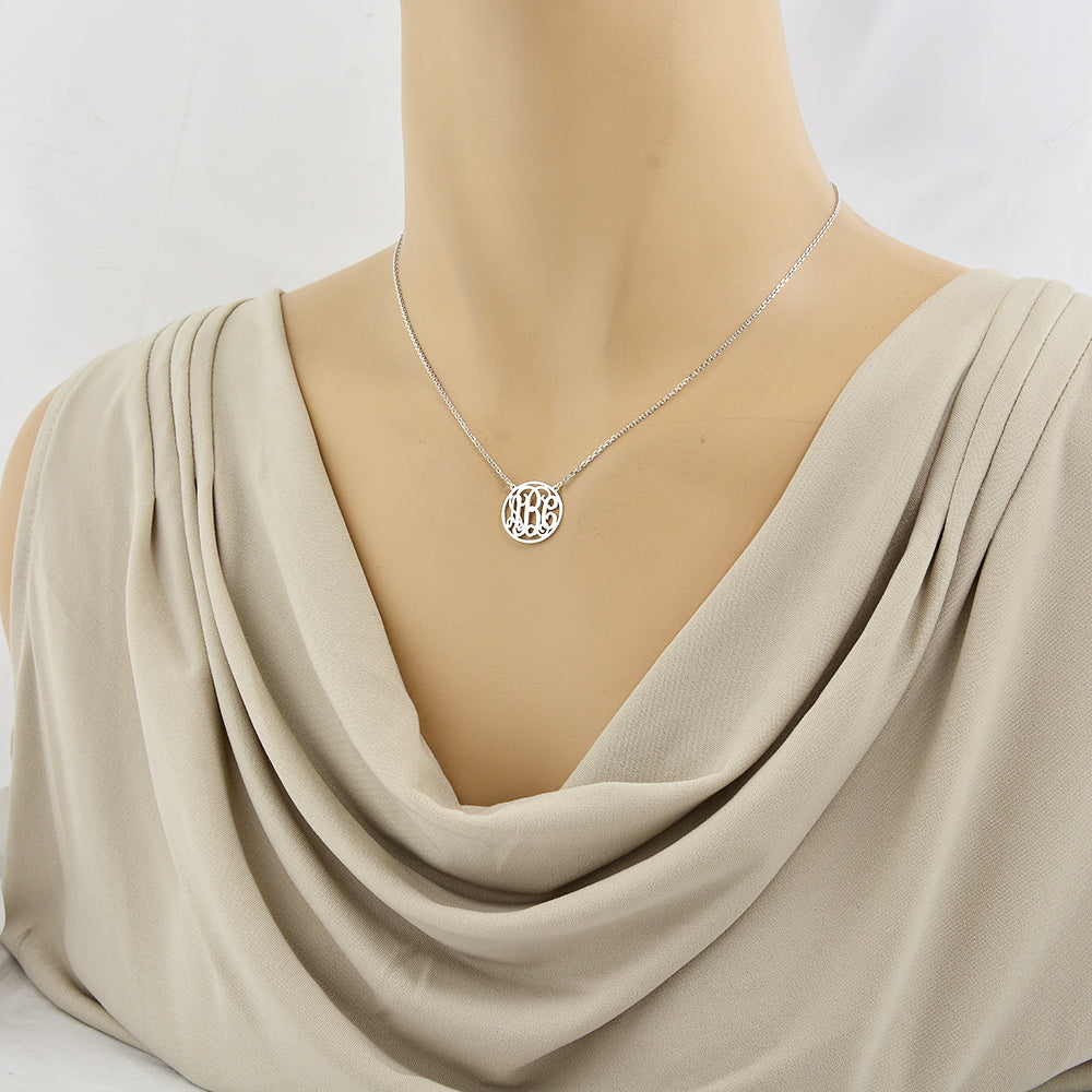 Woman wearing a custom sterling silver 3-initial circle monogram pendant necklace
