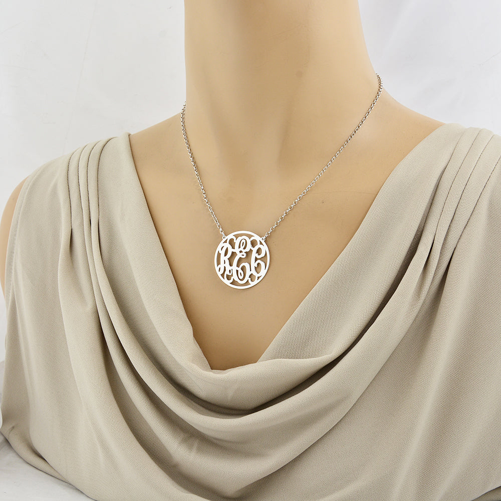 Model wearing a 1.25 inch sterling silver circle monogram necklace with personalized 3-letter initials