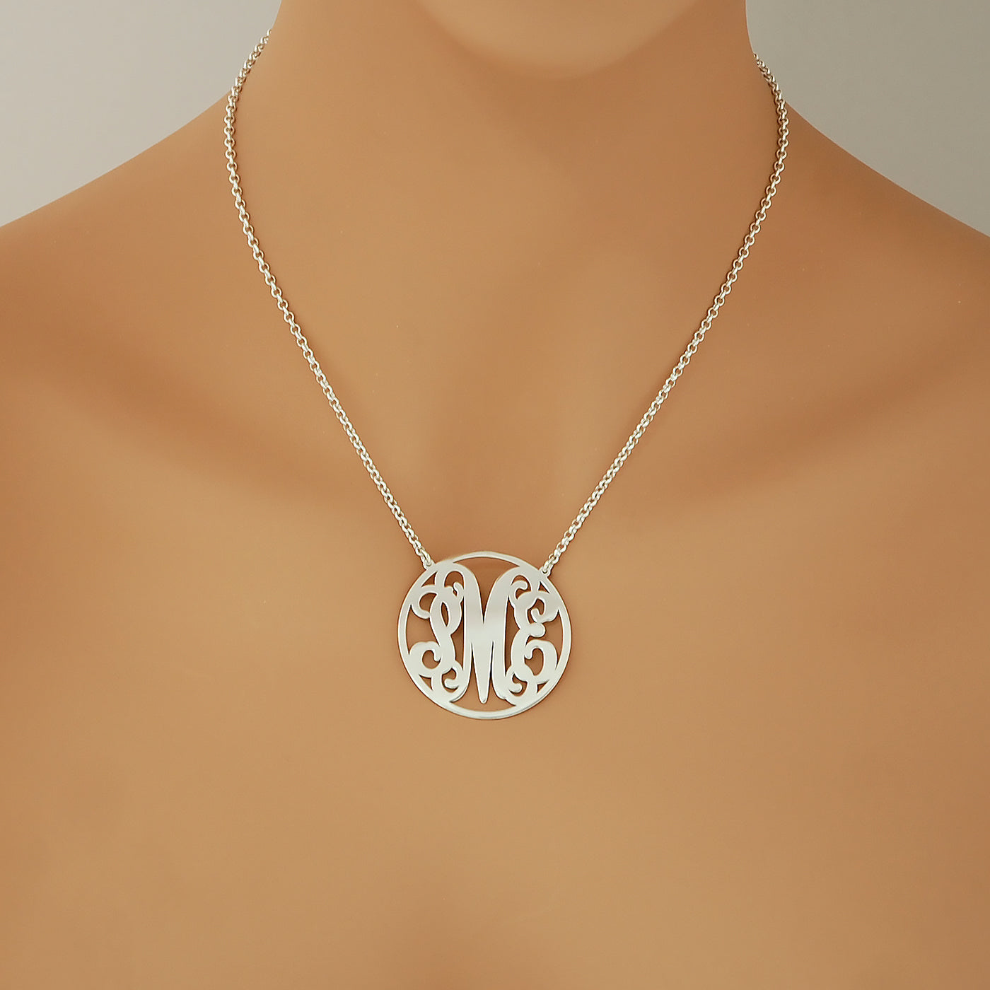 Woman wearing a custom 1.5-inch sterling silver circle monogram necklace