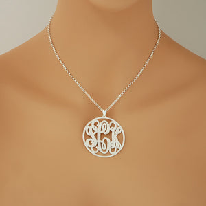 Woman wearing a personalized 1.75-inch sterling silver circle monogram necklace.