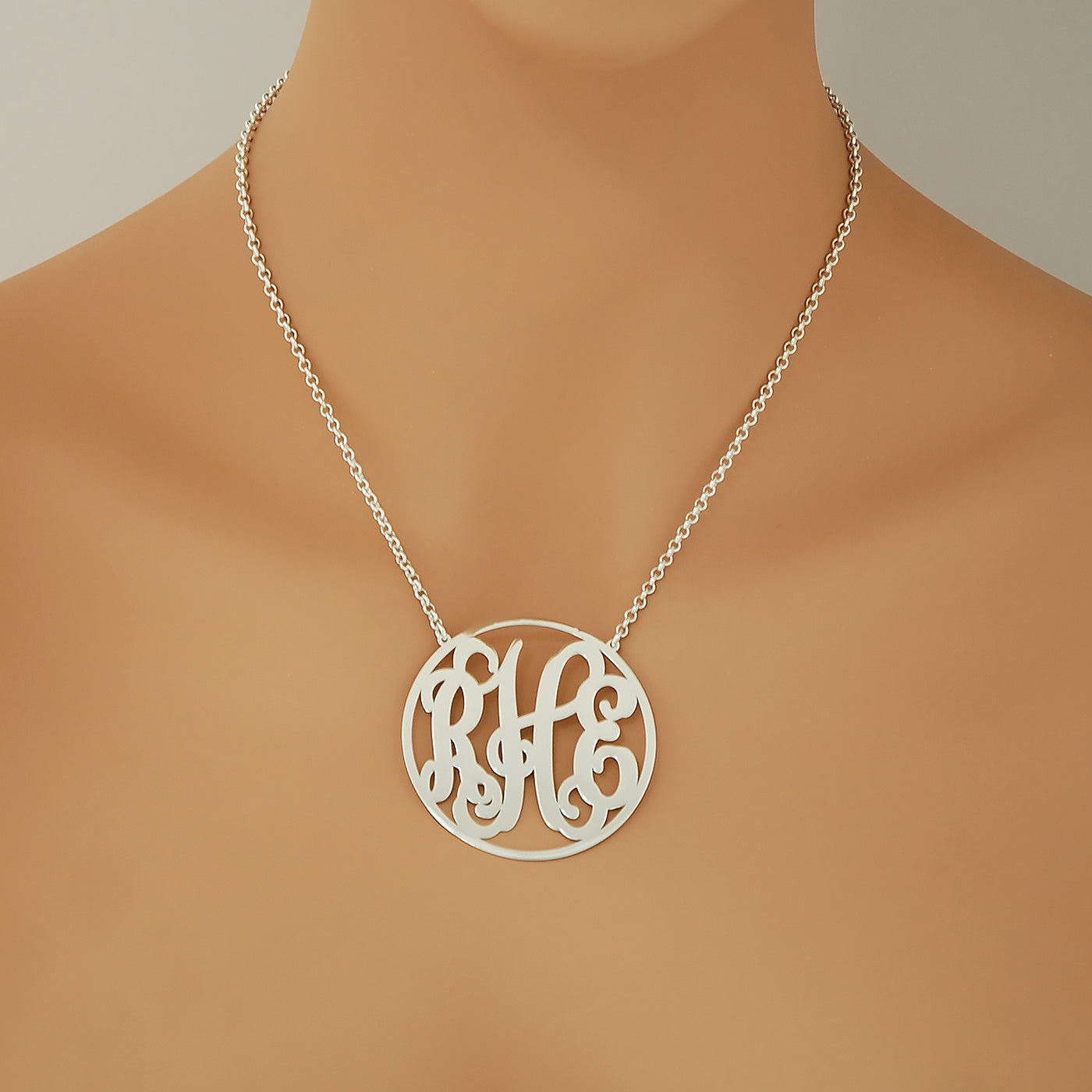 Model wearing a personalized sterling silver 3-initial circle monogram necklace.