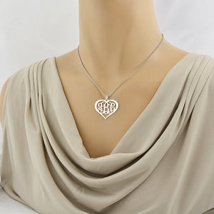 Woman wearing the custom sterling silver heart monogram pendant necklace on a delicate chain