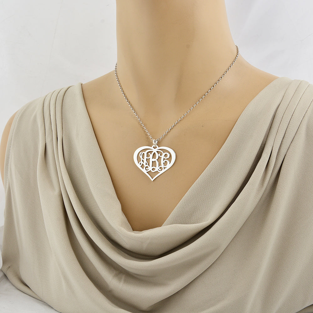 Model wearing a personalized sterling silver 3-initial heart monogram necklace