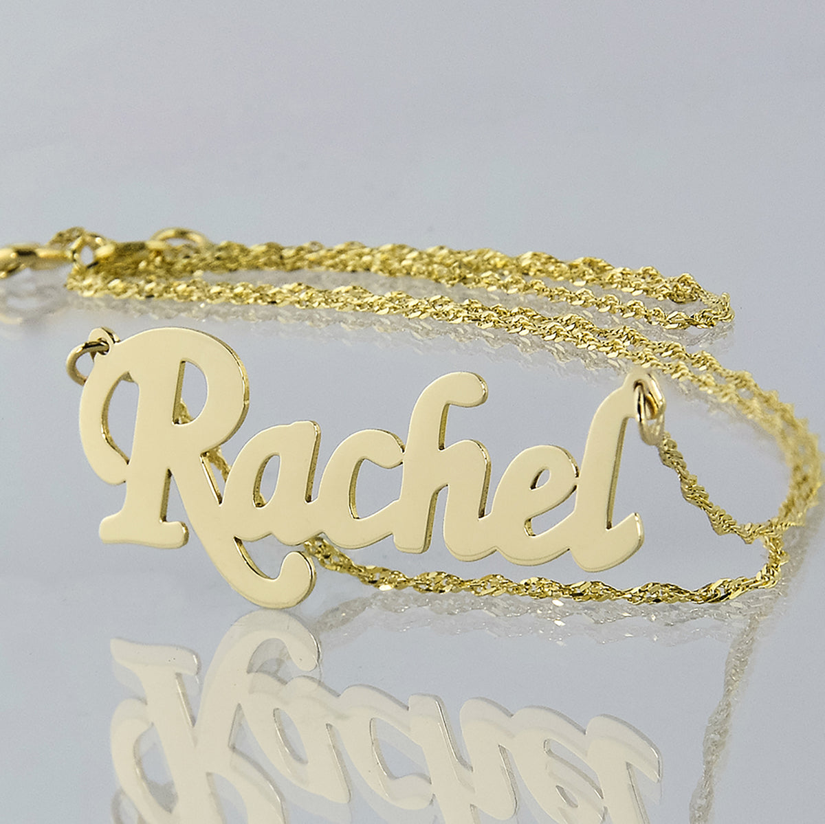 Personalized small 10k yellow gold script name necklace spelling Rachel with high-polish finish.