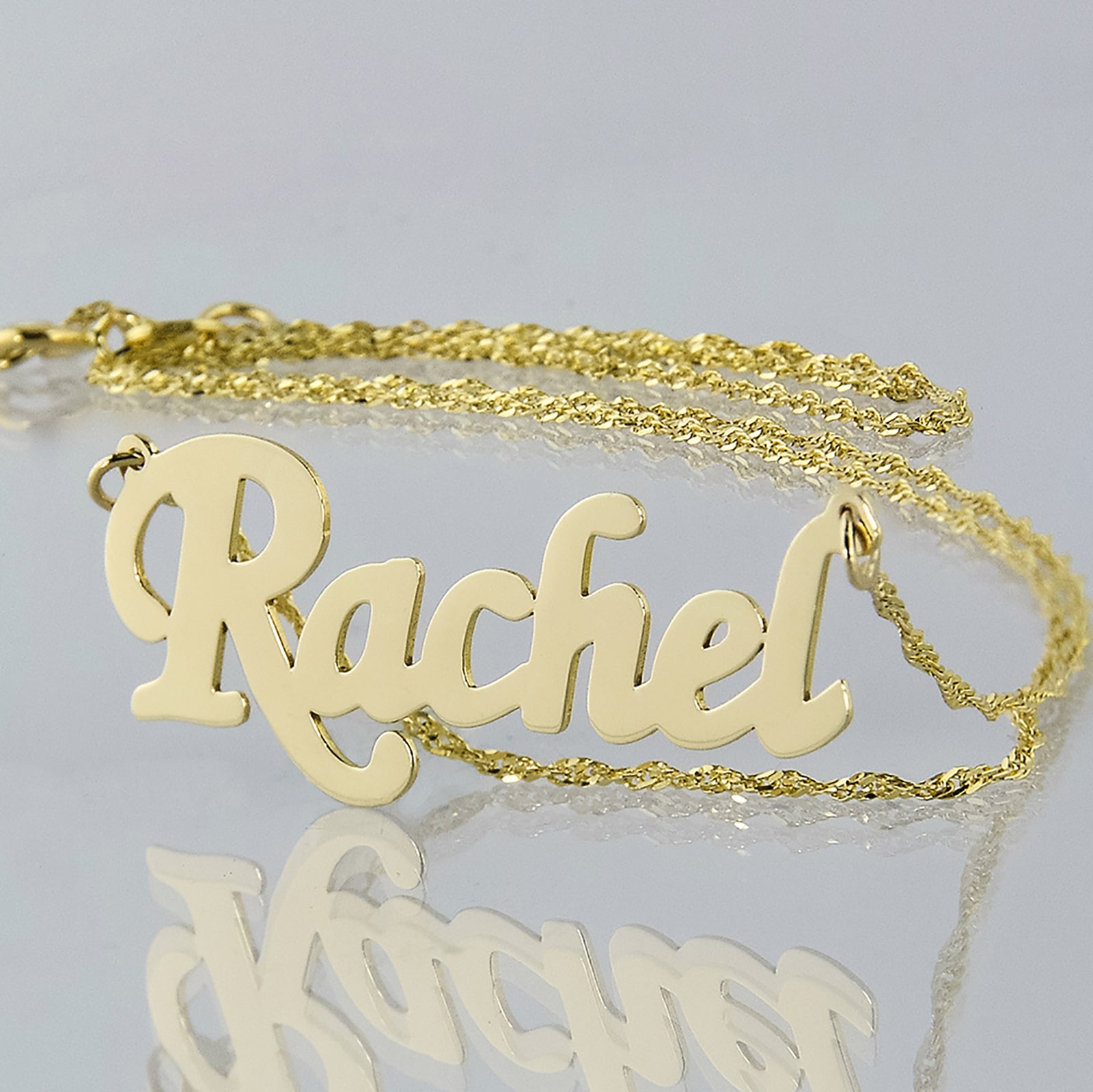Personalized small 10k yellow gold script name necklace spelling Rachel with high-polish finish.