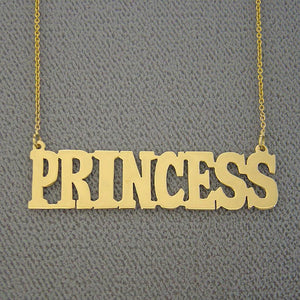 Close-up detail of solid 14k gold bold block lettering on a custom personalized nameplate necklace.