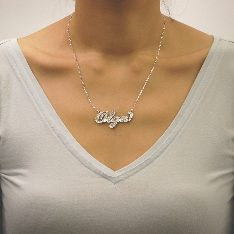 Model wearing a handcrafted custom 3D gold diamond nameplate necklace featuring a double-layer design.