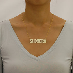 Model wearing a 2.5-inch custom gold block nameplate necklace layered on a 16-inch chain.