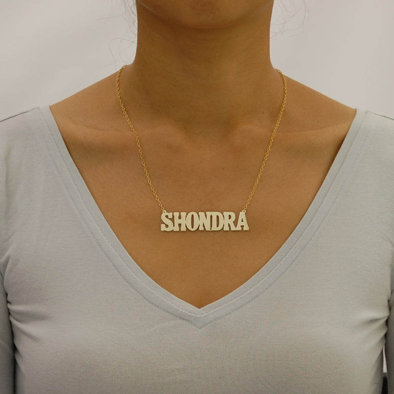 Model wearing a 2.5-inch custom gold block nameplate necklace layered on a 16-inch chain.