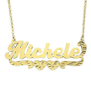 Close-up view of a handcrafted solid gold custom nameplate pendant with diamond cuts and a double-heart flourish.