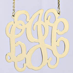 Solid gold custom three-initial monogram necklace worn as a pendant