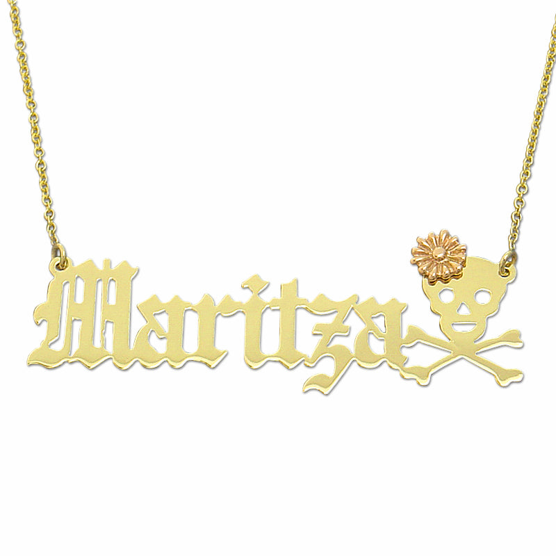 Close-up of a custom gothic Old English gold nameplate pendant featuring a rose gold flower and skull motif.