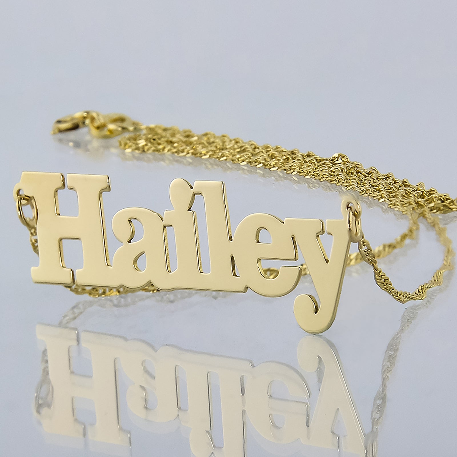 Custom small solid 10k yellow gold block font name necklace pendant spelling Hailey.
