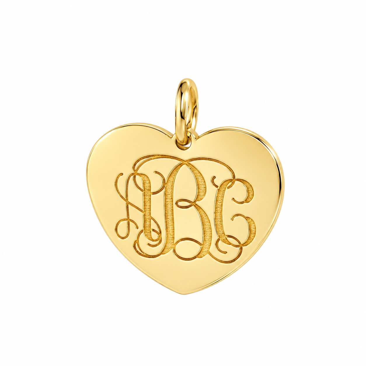Solid yellow gold heart pendant with laser-engraved three-letter monogram, personalized fine jewelry close-up