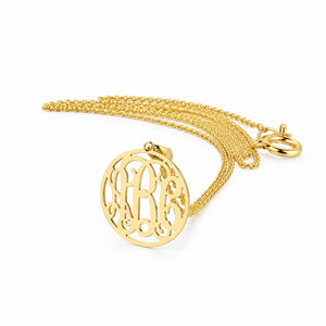 Custom solid gold 3-initial circle monogram pendant necklace on a delicate gold chain.