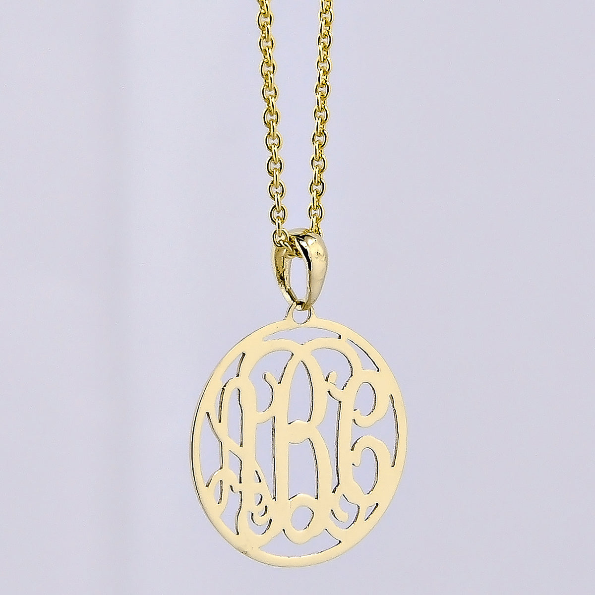 Extra-small solid gold 3-initial circle monogram pendant necklace on a light gray background.