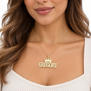 Woman wearing a personalized yellow gold crown nameplate necklace with Gregory in block letters