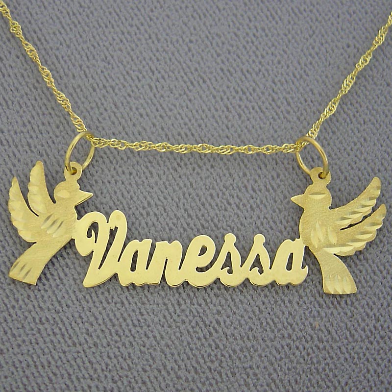 Close-up detail of diamond-cut dove design on solid gold custom name pendant.