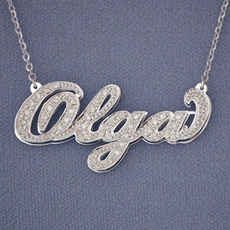 10K or 14K solid gold custom cursive diamond name necklace featuring handset genuine diamonds on a double-plate pendant.