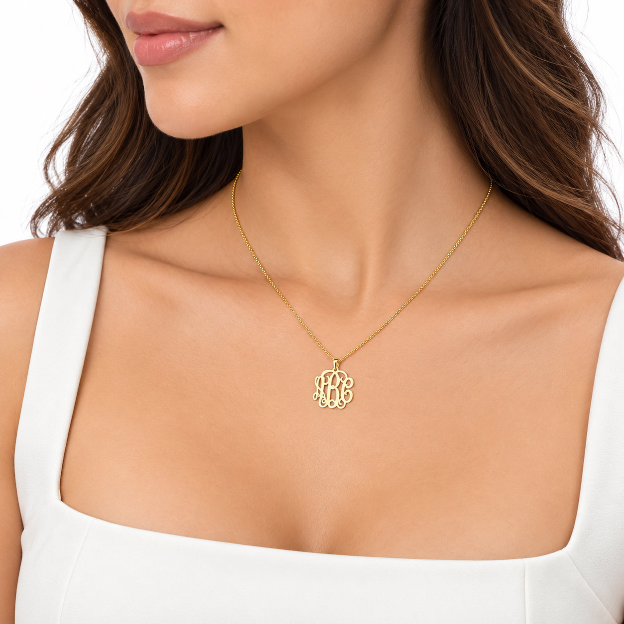 10k or 14k solid yellow gold mini three-initial monogram pendant necklace worn on a matching fine chain.