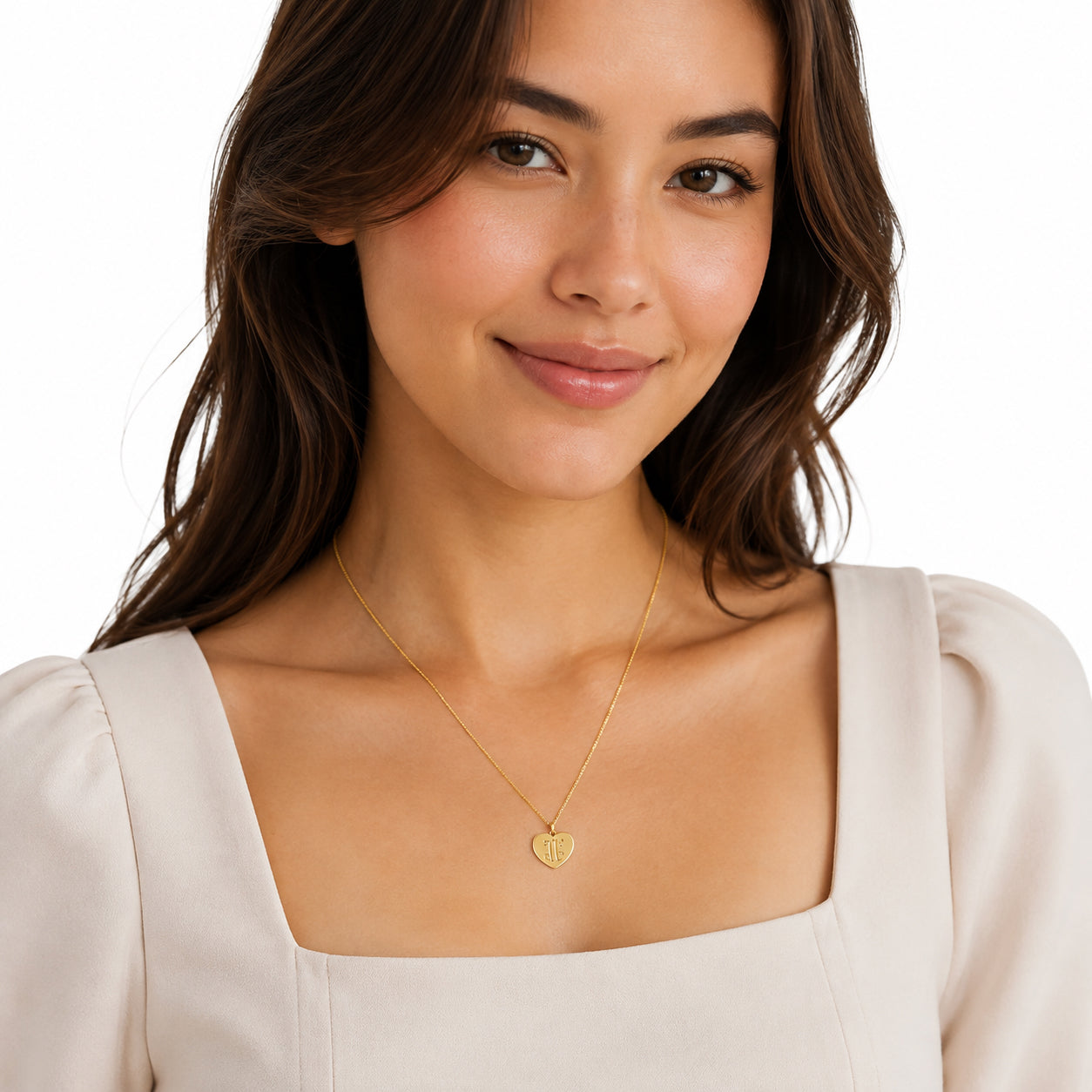 Woman wearing handcrafted solid gold monogram heart initial pendant necklace
