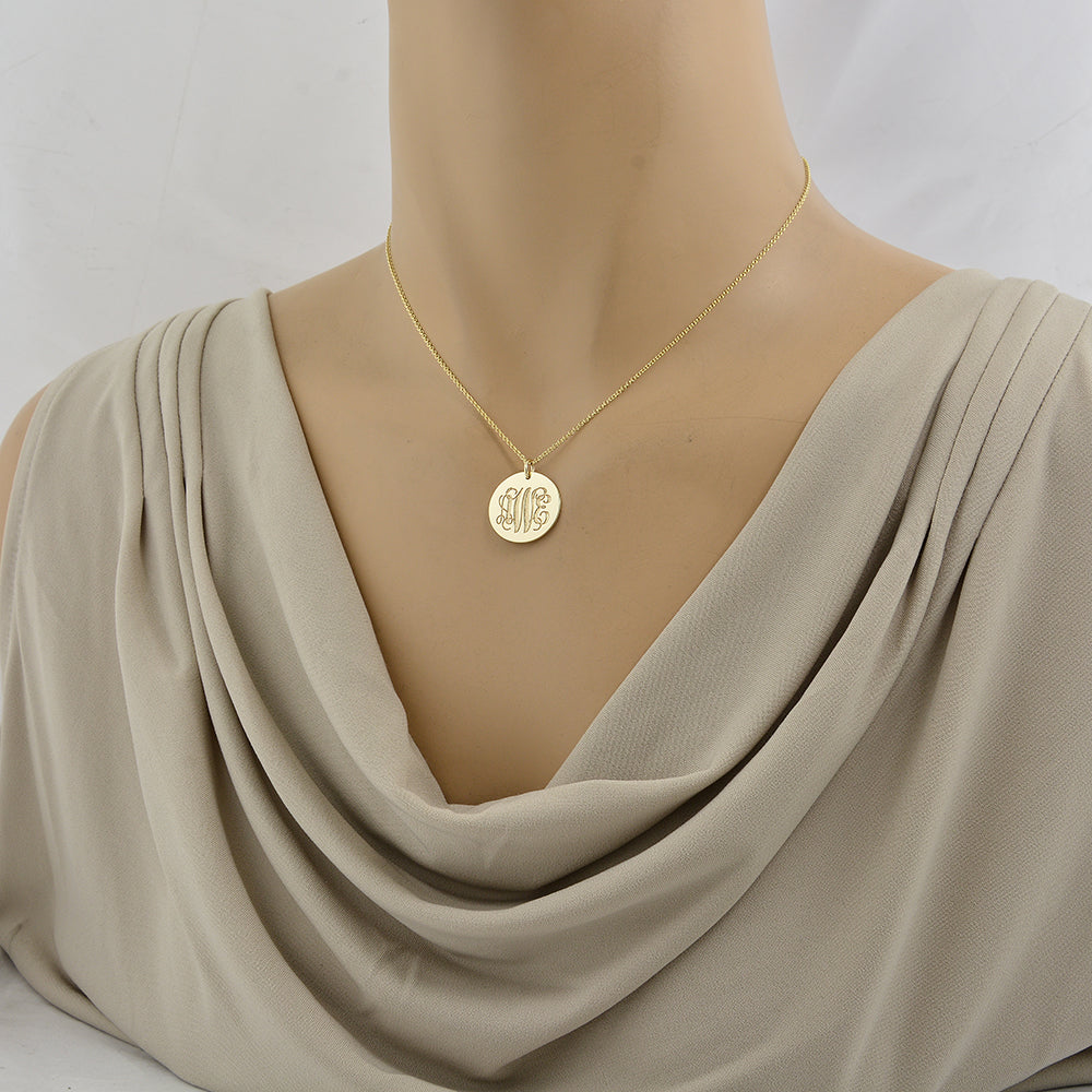 Mannequin wearing a 16-inch gold chain necklace with a personalized solid gold 3-initial monogram disc pendant.