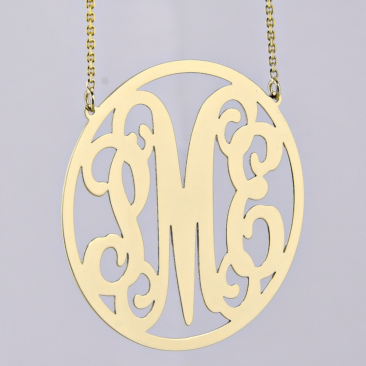 Handcrafted custom 10k or 14k solid gold circle monogram necklace made in Los Angeles.