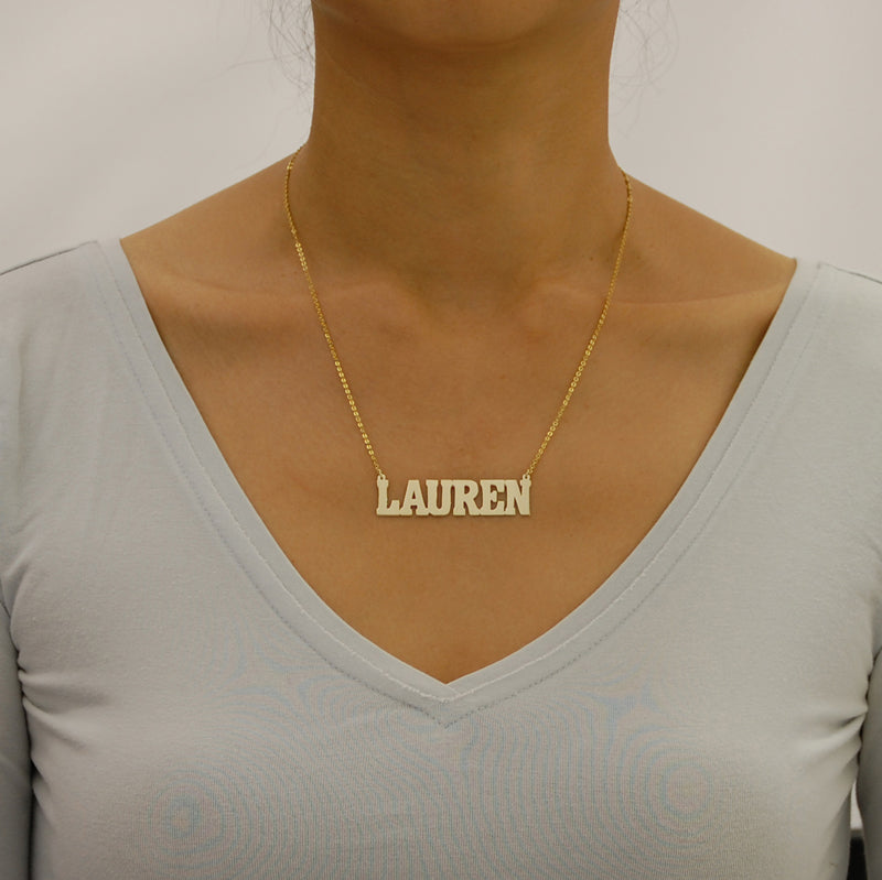 Model wearing a 2-inch personalized solid gold block nameplate necklace.