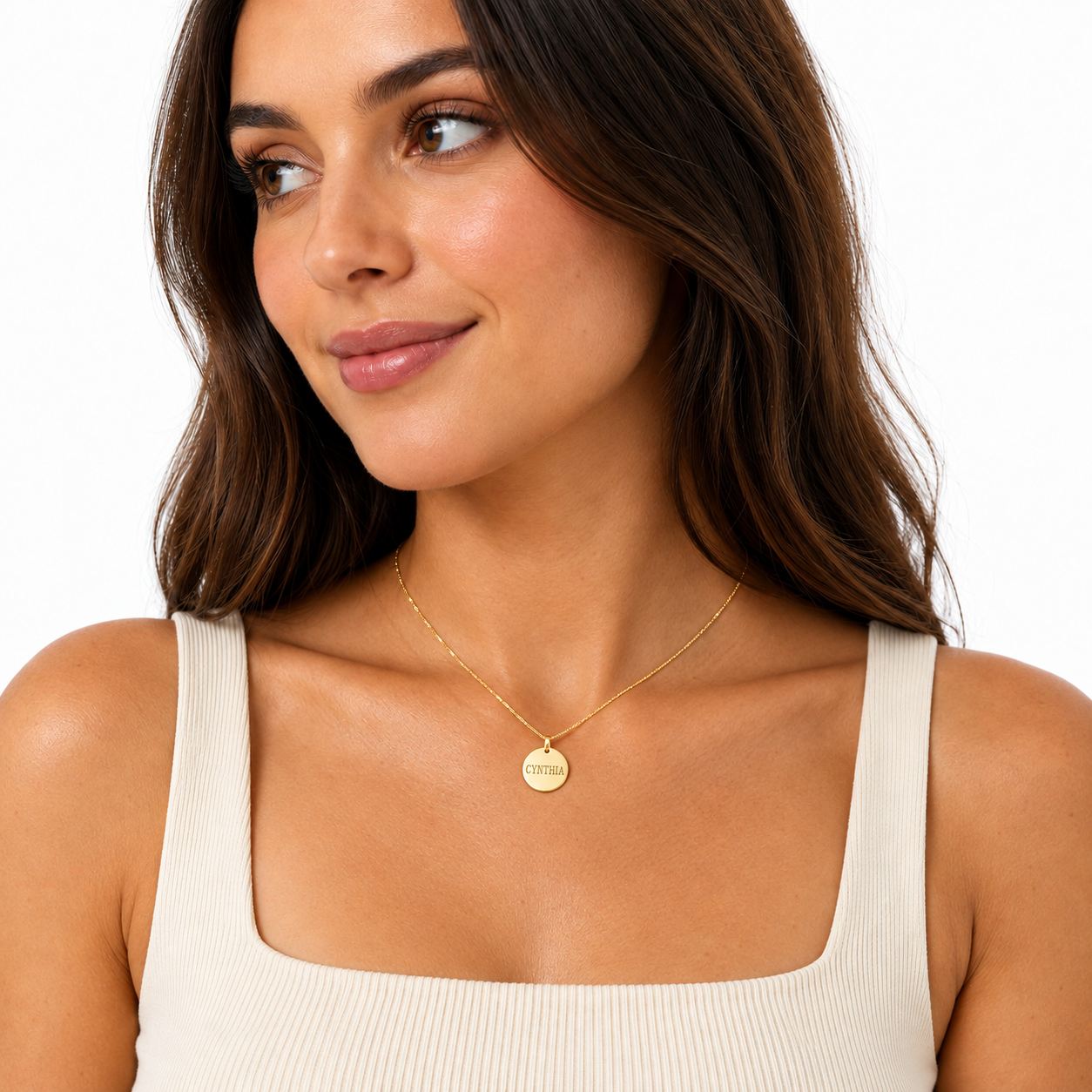 Woman wearing a dainty 14k solid gold personalized round disc charm pendant on a gold chain.