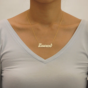 Model wearing a personalized 14k gold script name necklace displaying fine craftsmanship and fit.