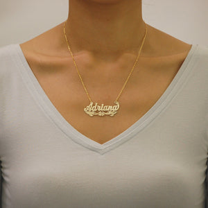 Close-up of a woman wearing the solid gold custom nameplate necklace on an 18-inch split chain.