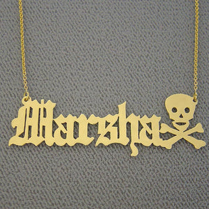 Personalized solid 14k yellow gold Old English font name necklace with custom skull and crossbones end motif.
