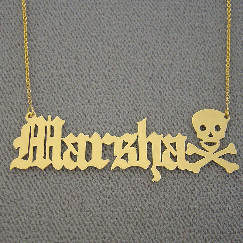 Personalized solid 14k yellow gold Old English font name necklace with custom skull and crossbones end motif.