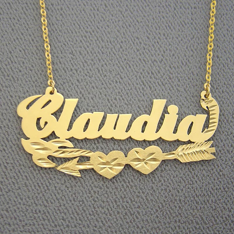 Personalized 10K solid gold script nameplate necklace spelling 'Claudia' with Cupid's arrow and dual heart design.