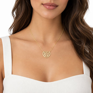 Model wearing a personalized 3-initial heart monogram necklace in solid gold.