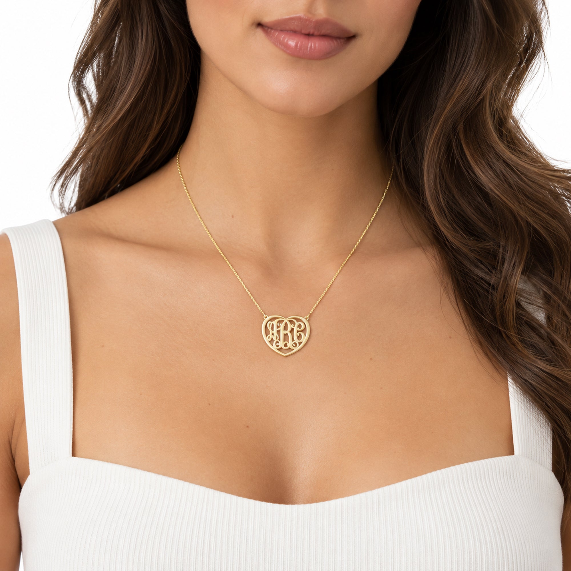 Model wearing a personalized 3-initial heart monogram necklace in solid gold.