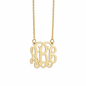 Close-up of a personalized mini 3-initial monogram pendant in 14k yellow gold