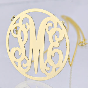 Personalized solid gold circle monogram necklace with three custom initials.