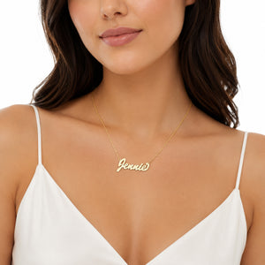 Model wearing a small cursive 14k solid gold nameplate necklace on a delicate Singapore chain.