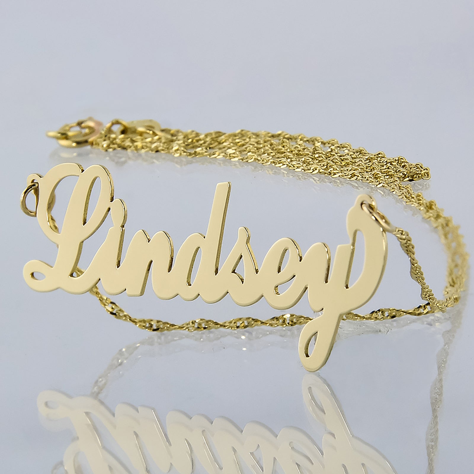 Small 14k yellow gold custom script name necklace sample featuring the name Lindsey.