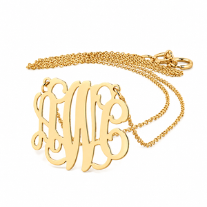 Small solid yellow gold three-initial monogram pendant with fine chain, close-up studio view