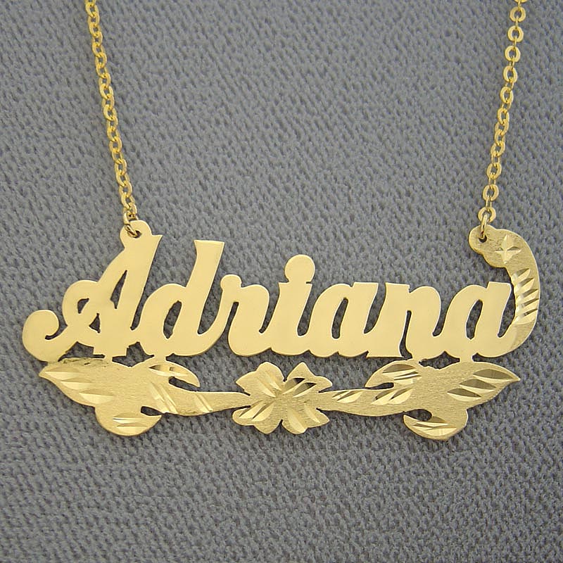Solid 14K gold custom nameplate necklace featuring 'Adriana' in script with floral diamond-cut detailing on a gold split chain.