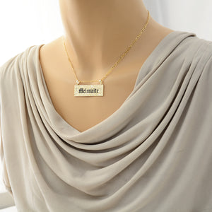 Woman wearing the custom solid 14k gold Hawaiian heirloom name pendant on a chain.