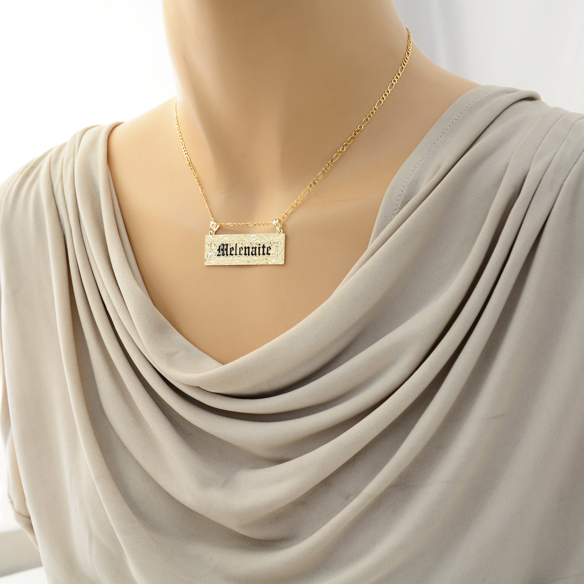 Woman wearing the custom solid 14k gold Hawaiian heirloom name pendant on a chain.