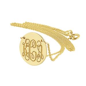 10k solid yellow gold round disc pendant engraved with a 3-letter monogram on a gold chain.