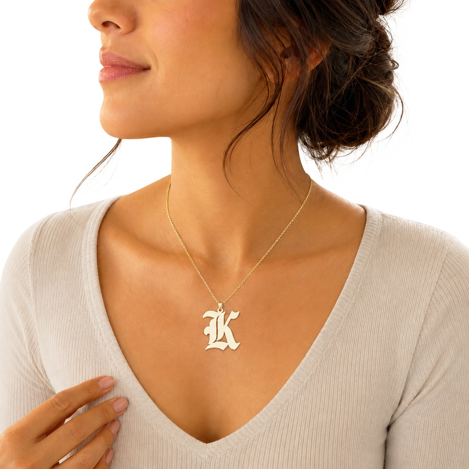 Woman wearing the solid gold Old English initial K pendant charm on a chain.