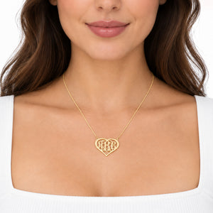 Model wearing a solid gold heart monogram necklace with a personalized three-initial pendant.