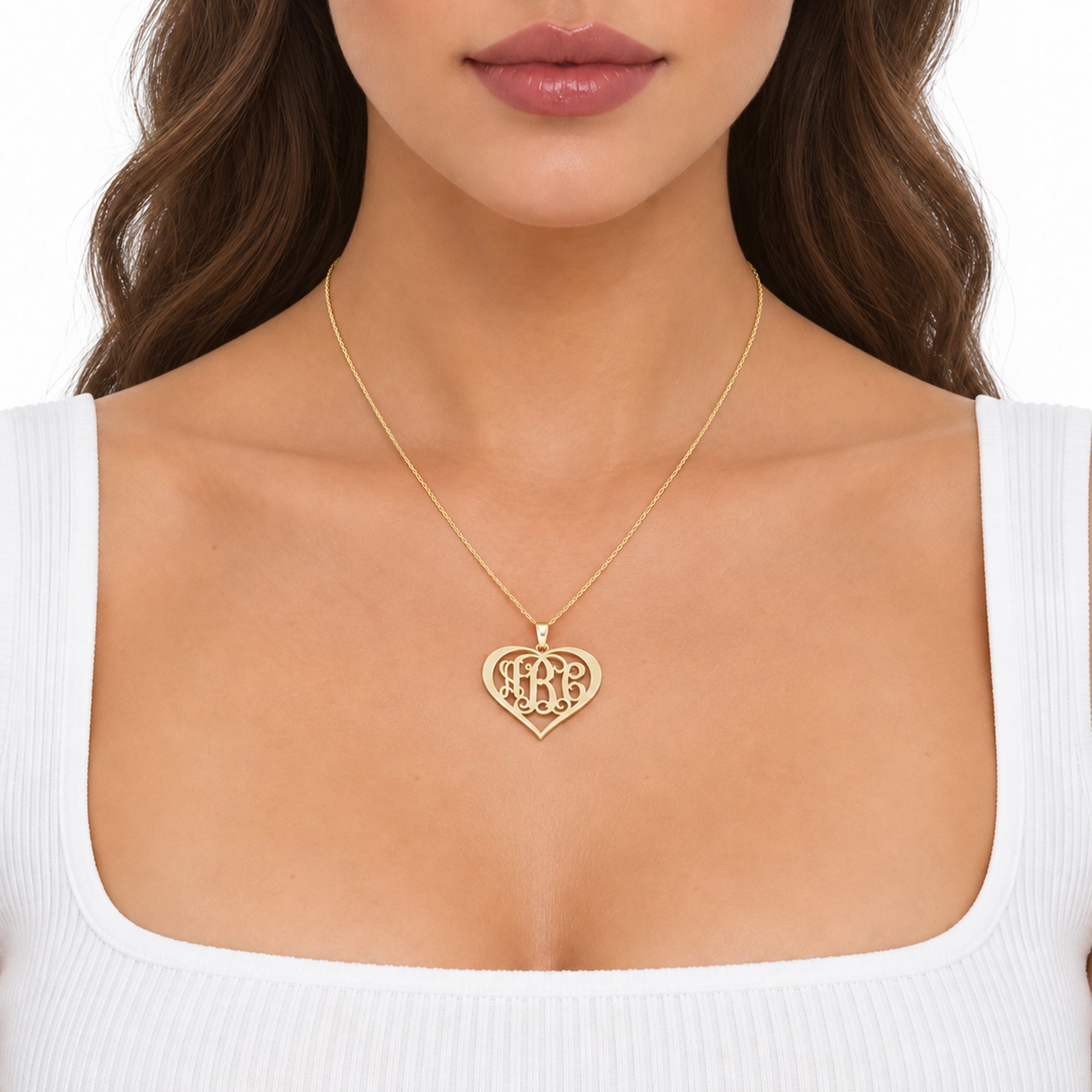Custom solid gold 3-initial heart monogram necklace worn on a model