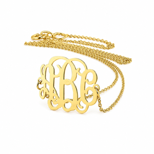 Solid 14k yellow gold three-initial sideways monogram necklace with fine chain on a white background