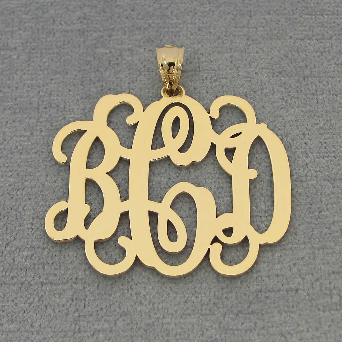 solid gold monogram charm featuring elegant cursive script.